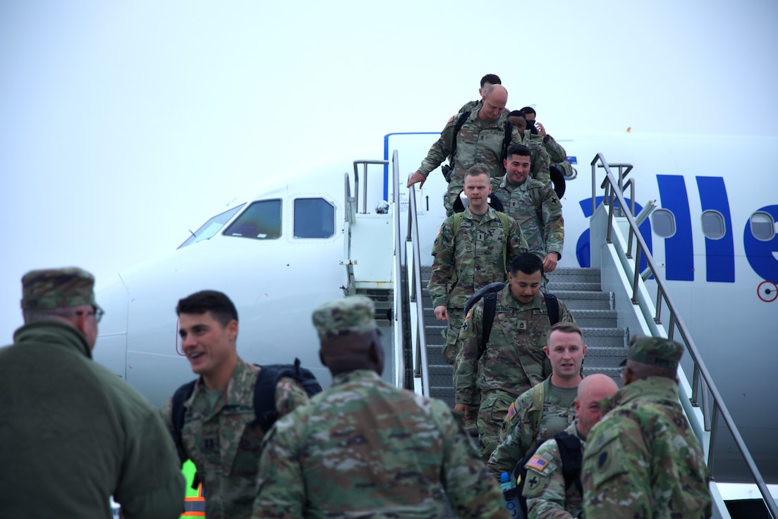 The second flight of Soldiers of the Illinois Army National Guard’s 2nd Battalion, 130th Infantry Regiment exits the plane at the Greater Rockford Airport.