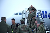 The second flight of Soldiers of the Illinois Army National Guard’s 2nd Battalion, 130th Infantry Regiment exits the plane at the Greater Rockford Airport.