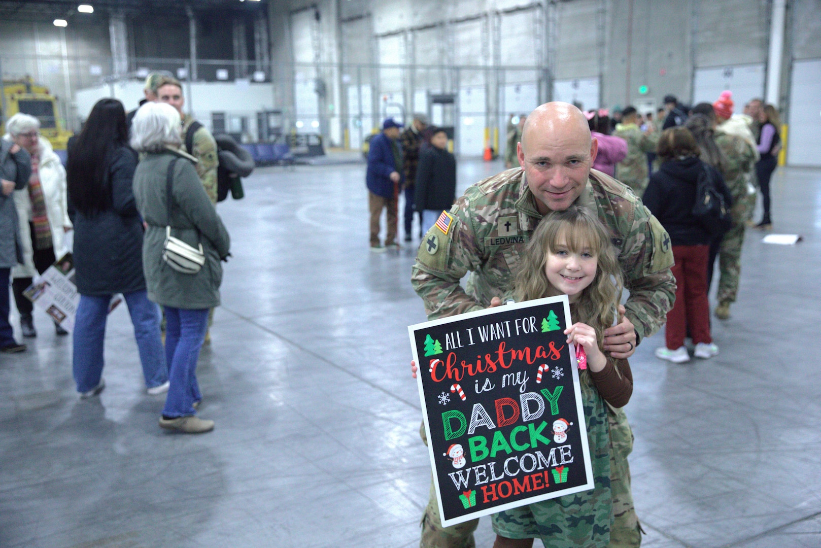 U.S. Army Chaplain 1st Lt. Merle Ledvina reunites with his family.