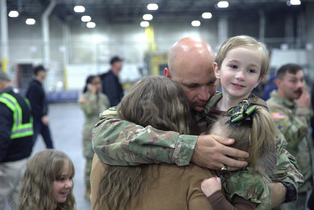 U.S. Army Chaplain 1st Lt. Merle Ledvina reunites with his family.