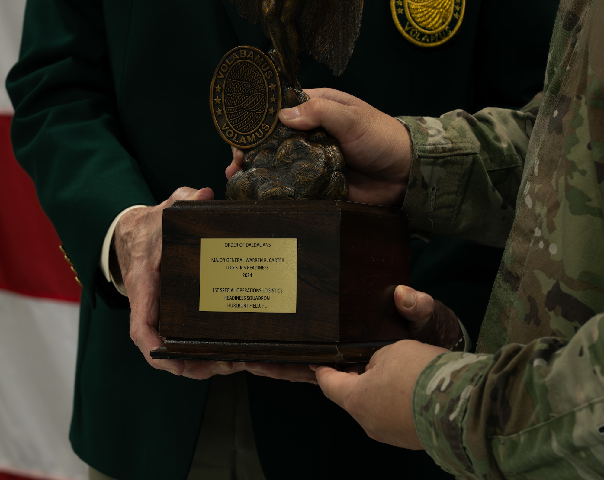 Retired U.S. Navy Capt. Mike Denkler, Order of Daedalians director, left, presents Lt. Col. Garrett Hernandez, 1st Special Operations Logistics Readiness Squadron commander, with the 2024 Daedalian Maj. Gen. Warren R. Carter Logistics Effectiveness award at Hurlburt Field, Florida, Nov. 24, 2025.
