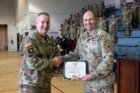 Lt. Col. Andrew V. Salmo, outgoing commander of the 1st Battalion, 178th Infantry Regiment, receives the Meritorious Service Medal from Col. Michael Kowalski, commander of the 33rd Infantry Brigade Combat Team.