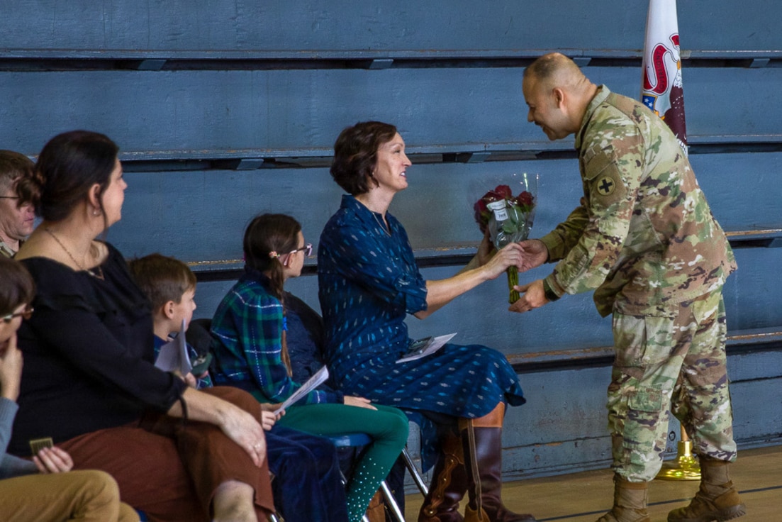 Jessica Salmo, wife of Lt. Col. Andrew V. Salmo, outgoing commander of the 1st Battalion, 178th Infantry Regiment, receives red roses during the battalion's change of command ceremony.