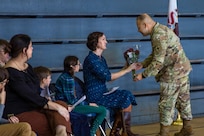 Jessica Salmo, wife of Lt. Col. Andrew V. Salmo, outgoing commander of the 1st Battalion, 178th Infantry Regiment, receives red roses during the battalion's change of command ceremony.