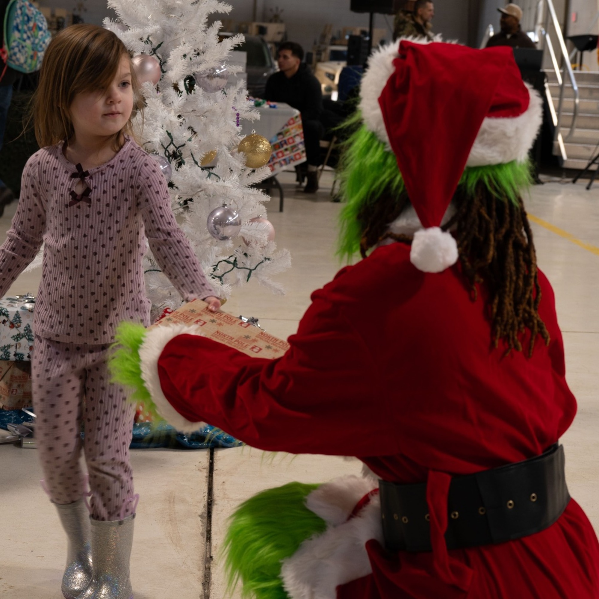 A child interacts with the grinch