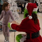 A child interacts with the grinch