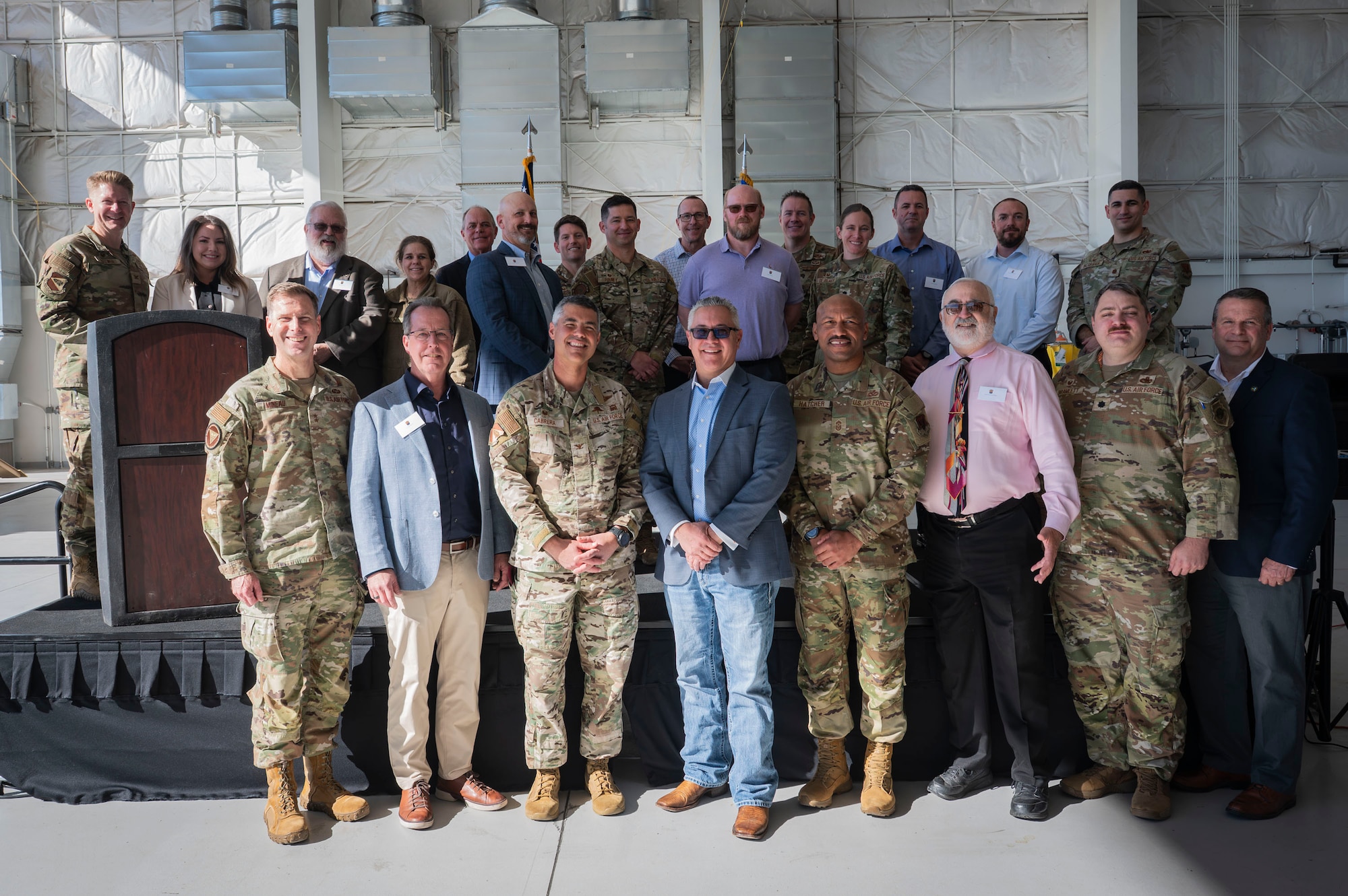 U.S. Air Force unit commanders and their incoming honorary commander civilian counterparts take a group photo during the Honorary Commanders Change of Command ceremony at Davis-Monthan Air Force Base, Arizona, Dec. 8, 2025. The honorary commander program strengthened ties between DM and prominent civilians within the Tucson community. (U.S. Air Force photo by Airman 1st Class Samantha Melecio)