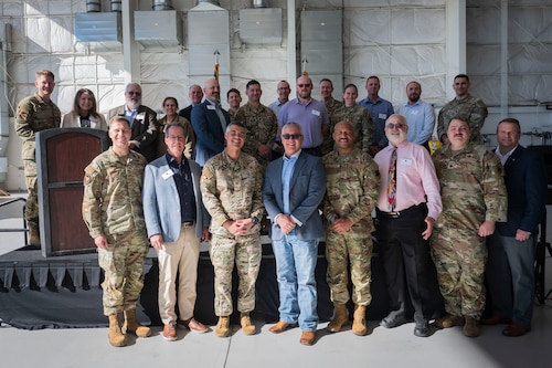 U.S. Air Force unit commanders and their incoming honorary commander civilian counterparts take a group photo during the Honorary Commanders Change of Command ceremony at Davis-Monthan Air Force Base, Arizona, Dec. 8, 2025. The honorary commander program strengthened ties between DM and prominent civilians within the Tucson community. (U.S. Air Force photo by Airman 1st Class Samantha Melecio)