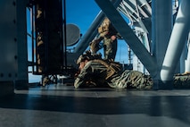 U.S. Marines with Battalion Landing Team 3/5, 11th Marine Expeditionary Unit, post security behind a .50-caliber special applications scoped rifle during a simulated strait transit on Wasp-class amphibious assault ship USS Boxer (LHD 4) in the Pacific Ocean, Dec. 7, 2025.
