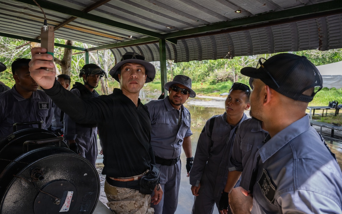 U.S. Navy Explosive Ordnance Disposal Chief Rick Hernandez, a team leader with Explosive Ordnance Disposal Mobile Unit (EODMU) 11 prepares to detonate a charge during a demolition range for Cooperation Afloat Readiness and Training (CARAT) Malaysia 2025 in Lumut, Malaysia, Dec. 8, 2025.