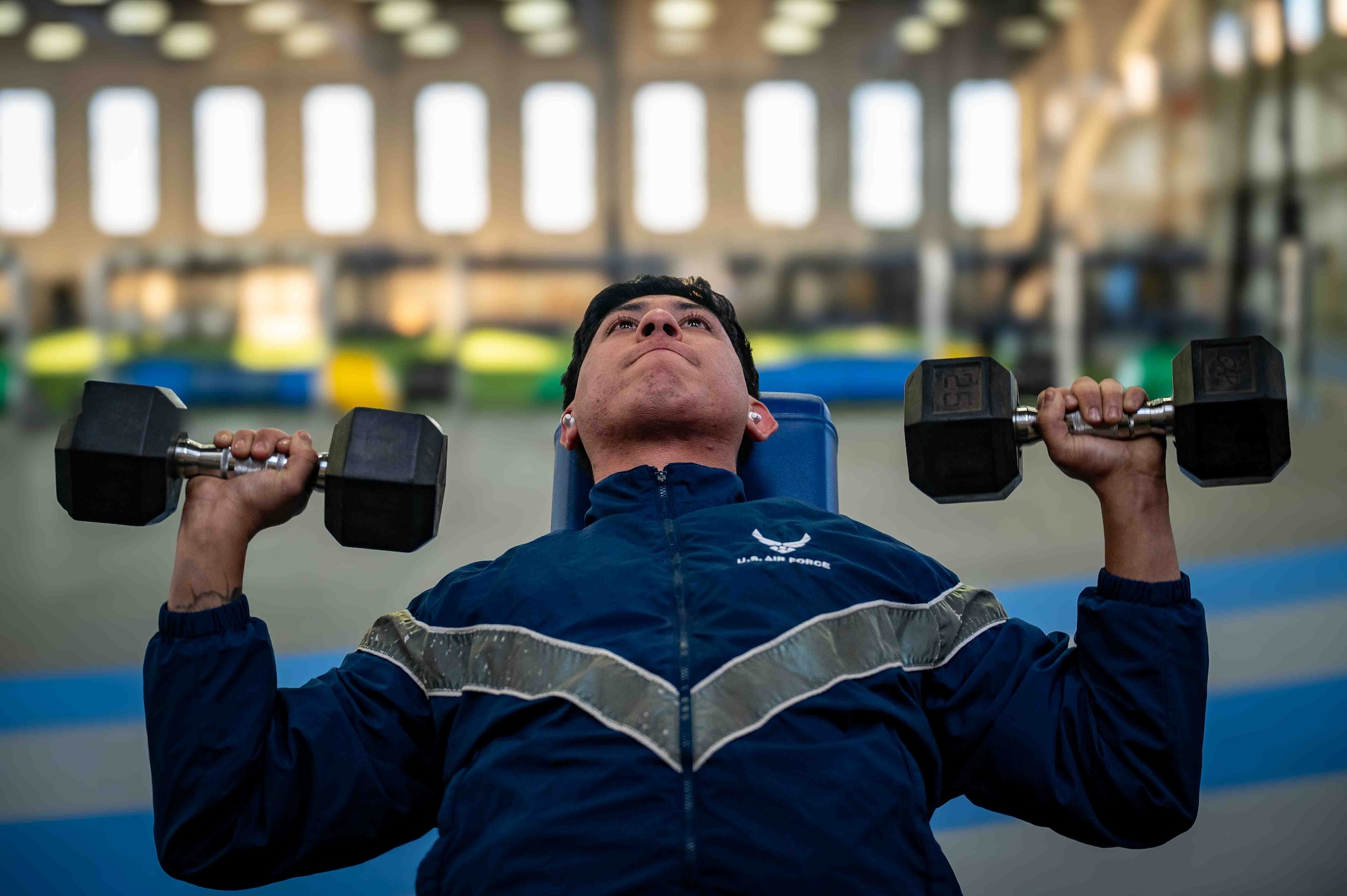 U.S. Air Force Senior Airman David Orellana, a vehicle maintainer assigned to the 673d Logistics Readiness Squadron, lifts weights at Hangar 5 at Joint Base Elmendorf-Richardson, Alaska, Dec. 8, 2025. Hangar 5 received major renovations as part of a $5 million congressional facility overhaul allocation aimed at improving warfighter fitness, lethality and readiness. (U.S. Air Force photo by Senior Airman Hunter Hites)