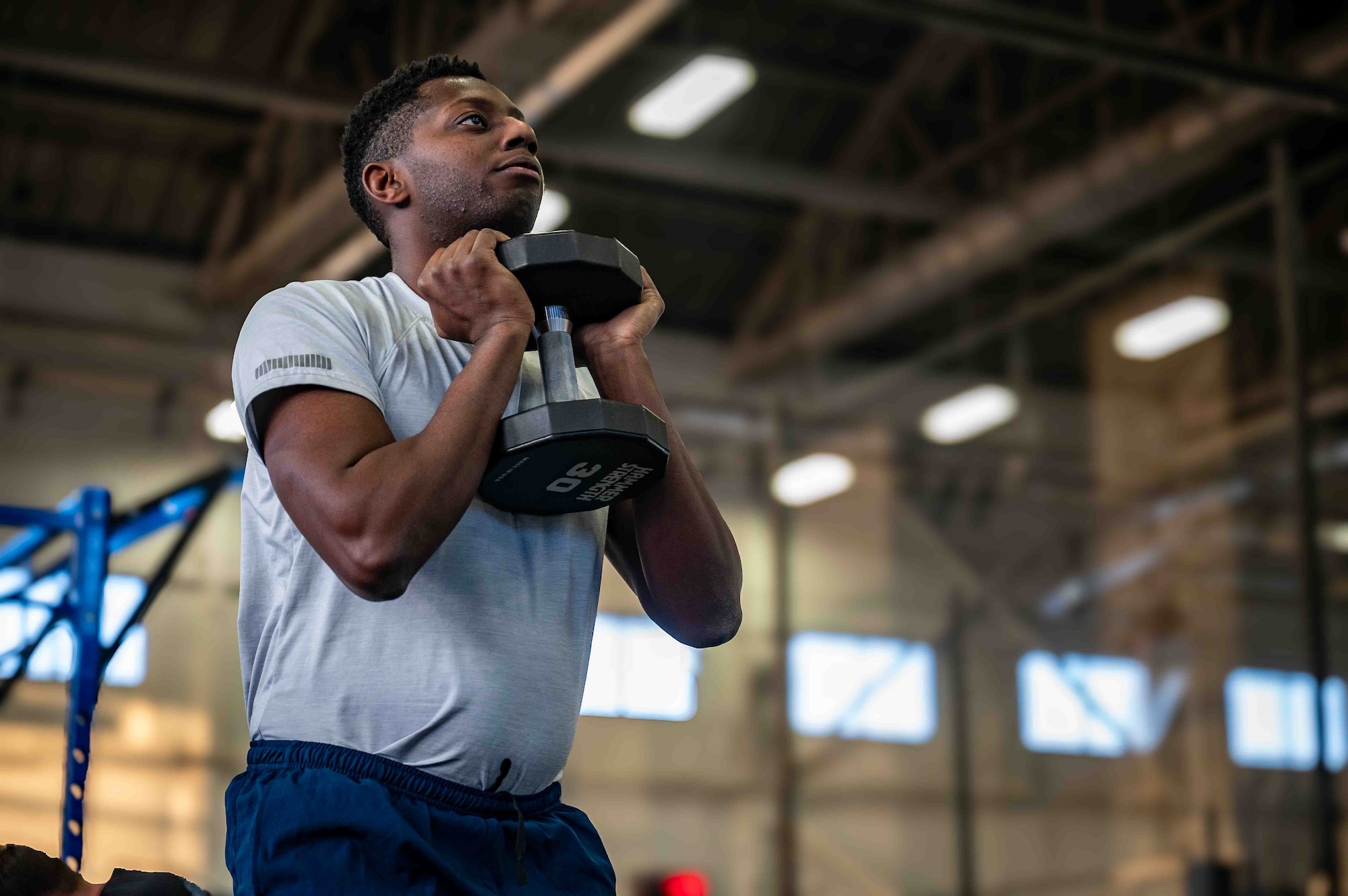 U.S. Air Force Airman 1st Class Jayson Forbai, a vehicle maintainer assigned to the 673d Logistics Readiness Squadron, lifts weights at Hangar 5 at Joint Base Elmendorf-Richardson, Alaska, Dec. 8, 2025. JBER is committed to fostering a culture of physical fitness to ensure the U.S. military remains the strongest and most lethal fighting force on the planet. (U.S. Air Force photo by Senior Airman Hunter Hites)