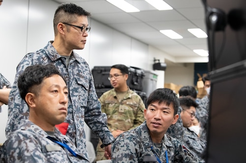 Members of the Japan Air Self-Defense Force perform console familiarization on day zero of the Japan-U.S. Testbed exercise.