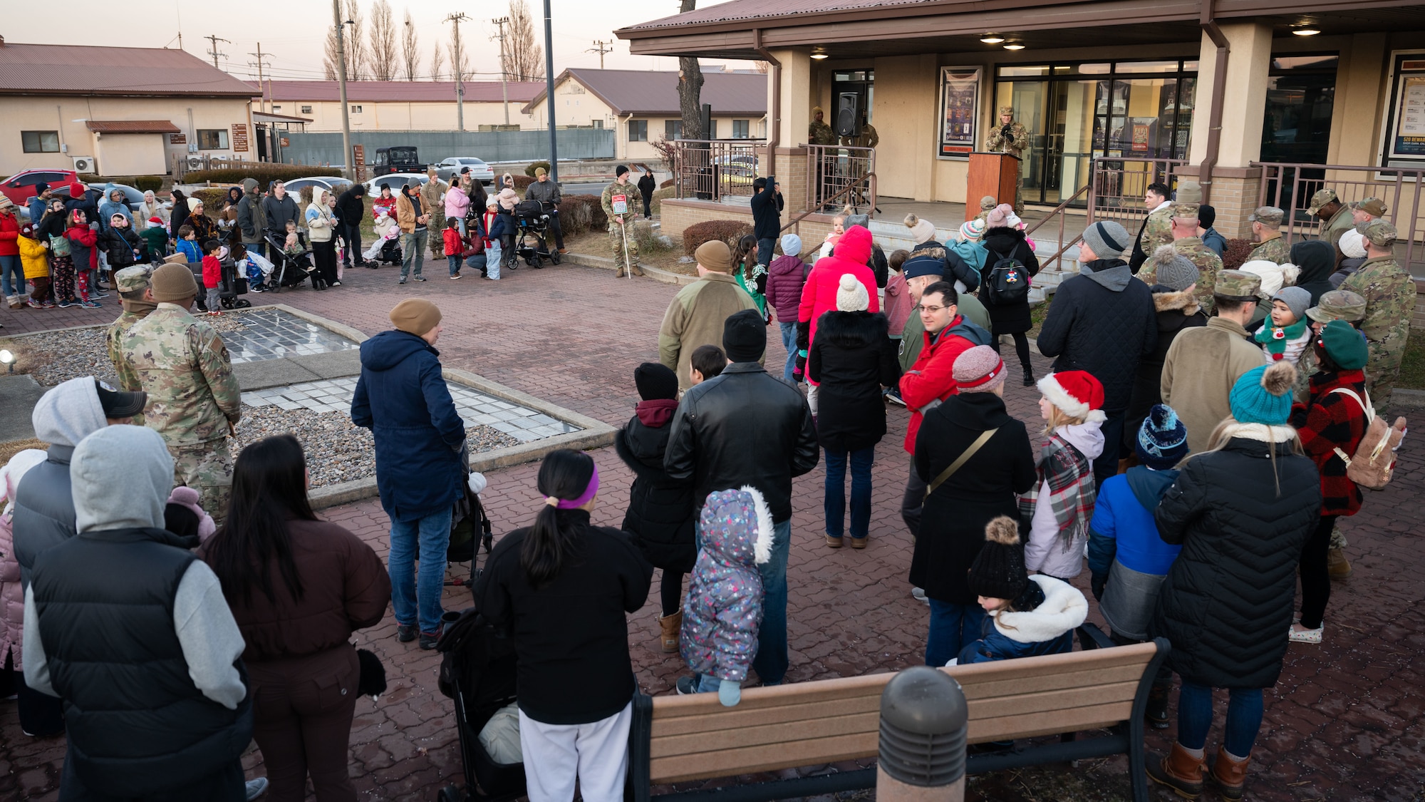 Members of the Osan community gather during the Christmas Tree Lighting Ceremony outside the base theater at Osan Air Base, Republic of Korea, Dec. 5, 2025. Airmen and families came together to enjoy festive activities to strengthen bonds across all ranks and units. (U.S. Air Force photo by Senior Airman Rome Bowermaster)