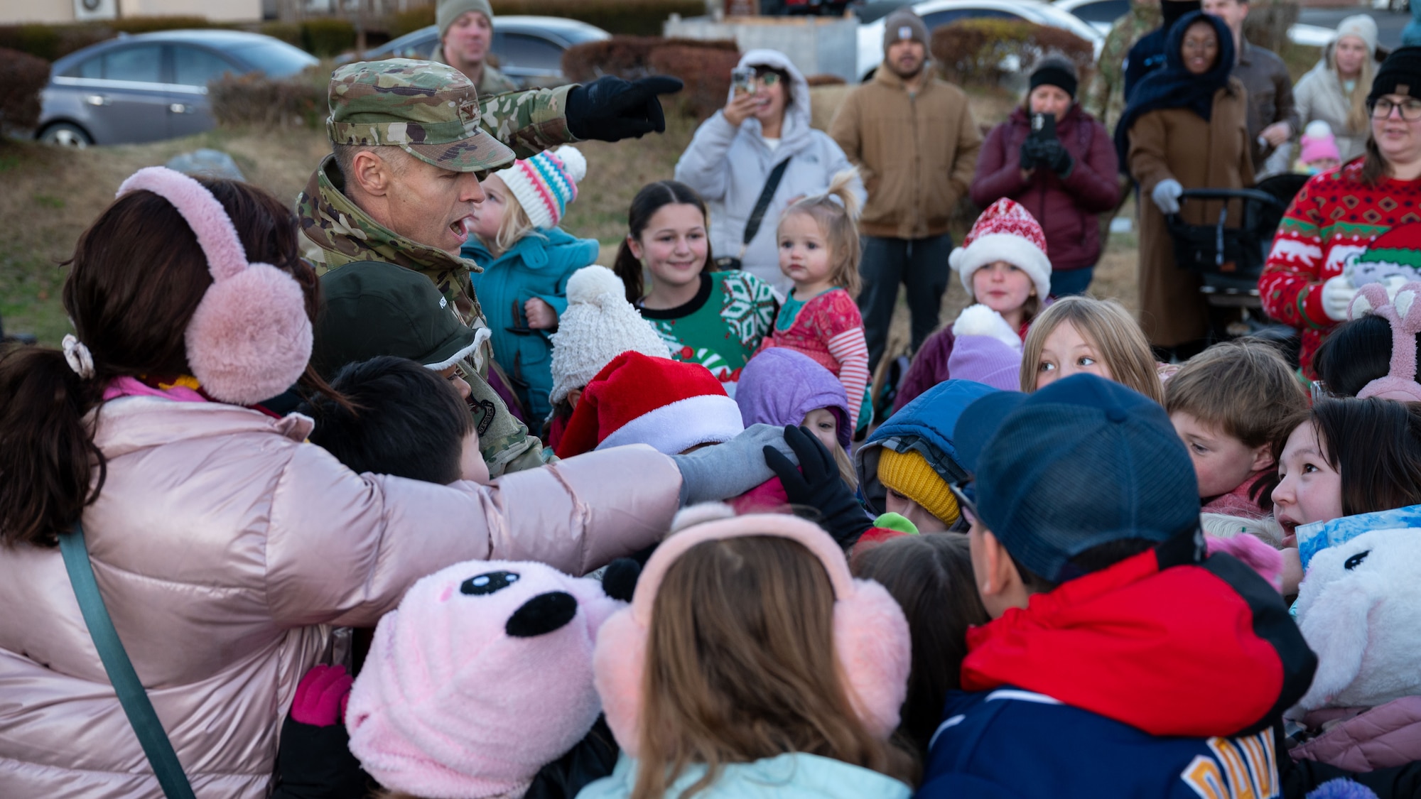 U.S. Air Force Col. Ryan Ley, 51st Fighter Wing commander, leads the Christmas Tree Lighting ceremony with children at Osan Air Base, Republic of Korea, Dec. 5, 2025. The gathering provided Airmen and families an opportunity to reconnect, celebrate and support one another during the holiday season. (U.S. Air Force photo by Senior Airman Rome Bowermaster)