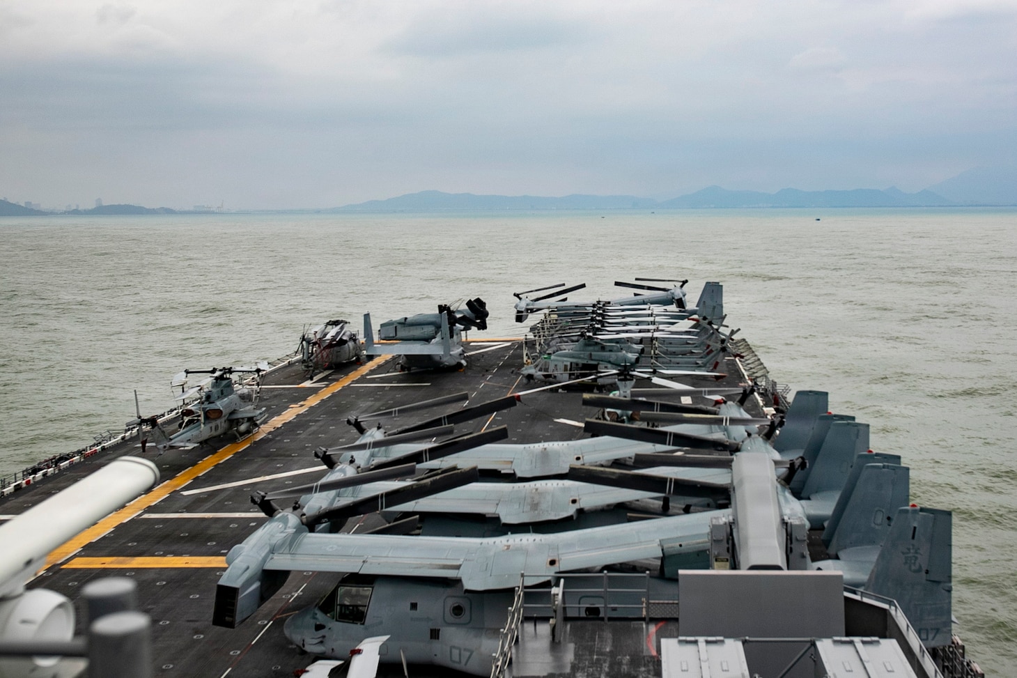 America-class amphibious assault ship USS Tripoli (LHA 7) pulls in to Da Nang, Vietnam for a port visit, Dec. 8, 2025.