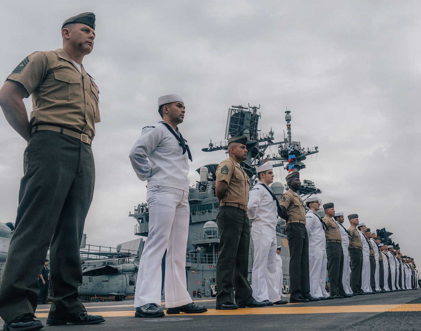 U.S. Marines and Sailors with the Tripoli Expeditionary Strike Group, man the rails as the forward-deployed amphibious assault ship USS Tripoli (LHA 7) arrives in Da Nang, Vietnam, Dec. 08, 2025.