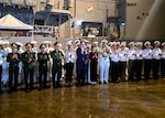 Ambassador Marc E. Knapper, U.S. ambassador to Vietnam, center; Consul General Melissa A. Brown, U.S. consulate general in Ho Chi Minh City, Vietnam, center-left; Nguyen Thi Thuy Trang, deputy director, Da Nang Department of Foreign Affairs, center-right; and Capt. Stephen Henz, commanding officer of the Ticonderoga-class guided-missile cruiser USS Robert Smalls (CG 62), second from center-right, participate in an arrival ceremony with members of the Vietnam People's Navy and Sailors assigned to Robert Smalls during a port visit to Da Nang, Vietnam, Dec. 8, 2025.