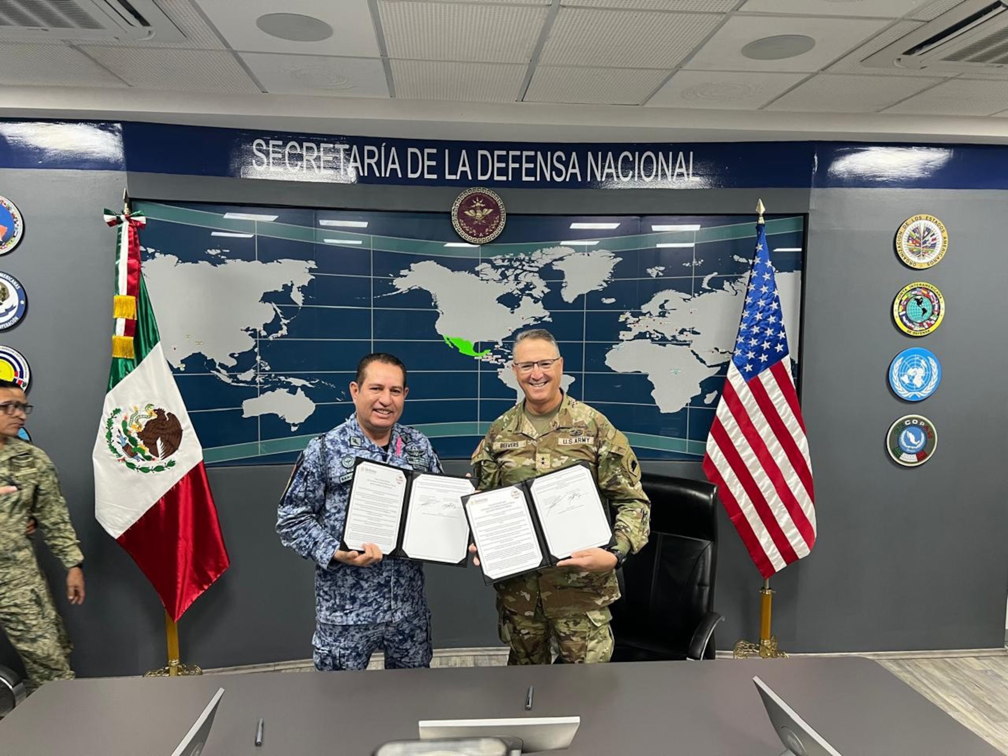 U.S. Army Maj. Gen. Matthew P. Beevers and Maj. Gen. Javier Sandoval Duenas, deputy chief of military doctrine of the National Defense Joint Headquarters Staff, or EMCDN, sign a letter of intent formalizing the agreement for Mexico to join the Department of War National Guard Bureau's State Partnership Program with the California National Guard.