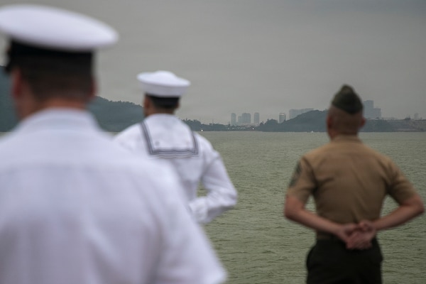 Sailors and Marines, assigned to the Tripoli Expeditionary Strike Group, man the rails for a port visit to Da Nang, Vietnam, Dec. 8, 2025.