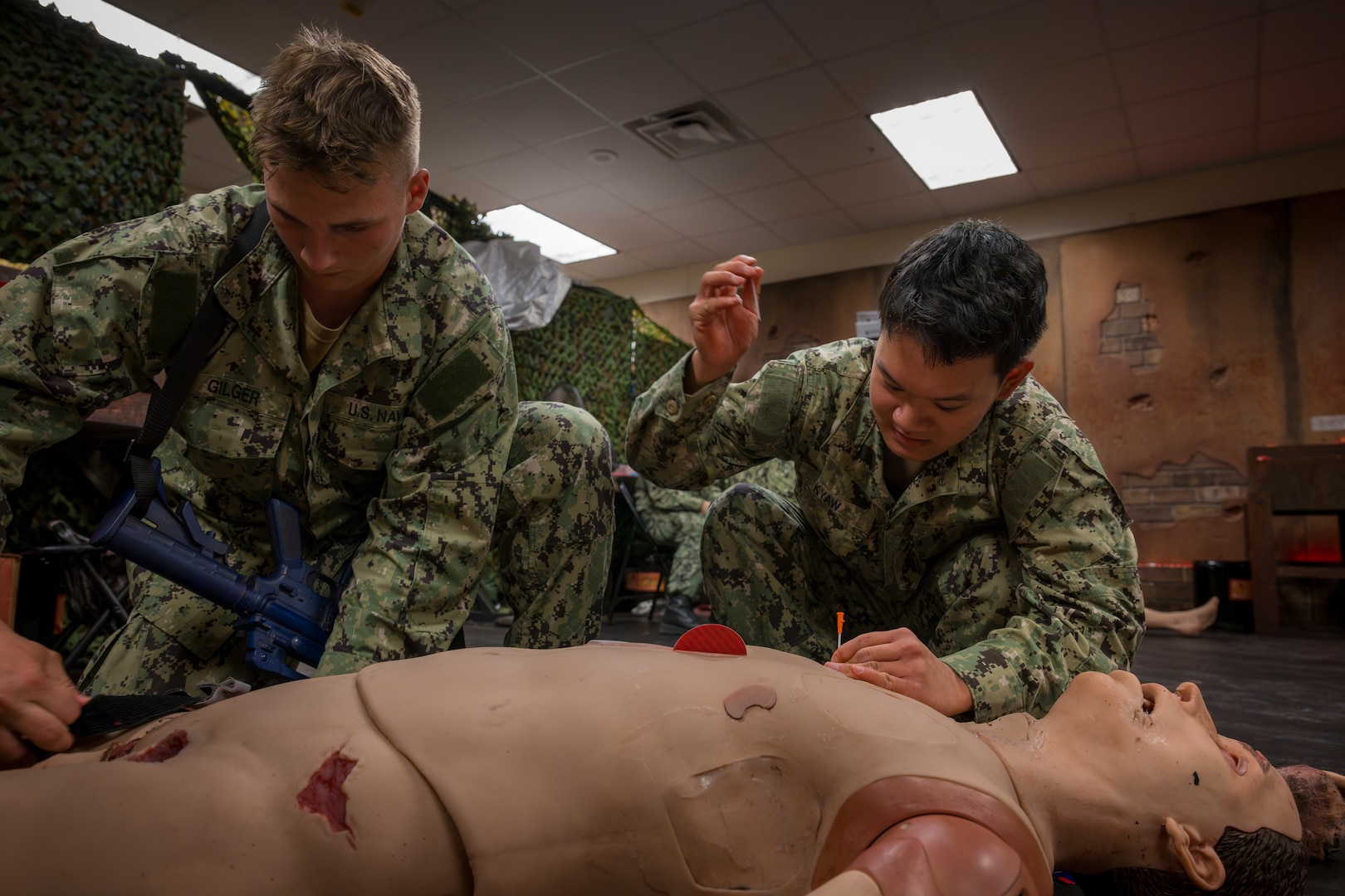 Hospitalman Nicole Acostacabrera, left, a Hospital Corpsman Basic student at the Navy Medicine Training Support Command, wraps up her final training evolution (FINEX) at Joint Base San Antonio, Texas, Sept. 09, 2025. At the FINEX, HCB students put their combat lifesaver skills to the test, mastering crucial battlefield medical techniques like tourniquet application, airway management and medication administration. Successfully completing this final assessment is the last step toward graduation and on to the fleet where they will play a vital role in the well-being of U.S. Navy and U.S. Marine Corps service members and their families. (U.S. Navy photo by Malcolm McClendon).