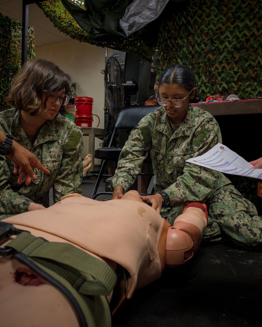 Hospitalman Recruit Melanie Vasquez, right, a Hospital Corpsman Basic student at the Navy Medicine Training Support Command, wraps up her final training evolution (FINEX) at Joint Base San Antonio, Texas, Sept. 09, 2025. At the FINEX, HCB students put their combat lifesaver skills to the test, mastering crucial battlefield medical techniques like tourniquet application, airway management and medication administration. Successfully completing this final assessment is the last step toward graduation and on to the fleet where they will play a vital role in the well-being of U.S. Navy and U.S. Marine Corps service members and their families. (U.S. Navy photo by Malcolm McClendon).