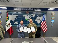 U.S. Army Maj. Gen. Matthew P. Beevers and Maj. Gen. Javier Sandoval Duenas, deputy chief of military doctrine of the National Defense Joint Headquarters Staff, or EMCDN, sign a letter of intent formalizing the agreement for Mexico to join the Department of War National Guard Bureau's State Partnership Program with the California National Guard.