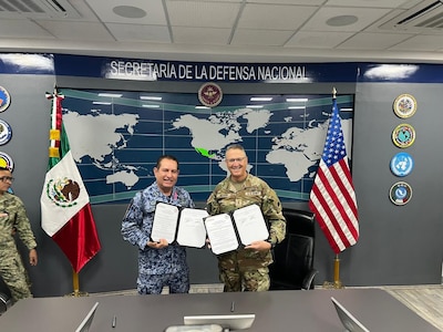 U.S. Army Maj. Gen. Matthew P. Beevers and Maj. Gen. Javier Sandoval Duenas, deputy chief of military doctrine of the National Defense Joint Headquarters Staff, or EMCDN, sign a letter of intent formalizing the agreement for Mexico to join the Department of War National Guard Bureau's State Partnership Program with the California National Guard.