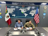 U.S. Army Maj. Gen. Matthew P. Beevers and Maj. Gen. Javier Sandoval Duenas, deputy chief of military doctrine of the National Defense Joint Headquarters Staff, or EMCDN, sign a letter of intent formalizing the agreement for Mexico to join the Department of War National Guard Bureau's State Partnership Program with the California National Guard.