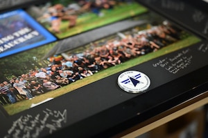 A retirement gift for Gordon Kordyak lies on a table during a social gathering, here, Dec. 4, 2025. Kordyak served as the Department of the Air Force’s Program Executive Office for Command, Control, Communications and Battle Management’s first deputy program executive officer. He is on terminal leave and set to officially separate in January 2026. Kordyak completed more than 19 years of government service and was instrumental in bringing together the Air Force and Space Force capabilities that make up the DAF BATTLE NETWORK. (Official Air Force Photo by Richard Blumenstein).