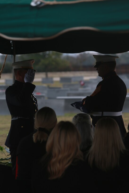 U.S. Marine Corps Lt. Gen. Leonard F. Anderson IV, commander, Marine Forces Reserve and Marine Forces South, salutes an honorarily given American Flag during memorial service for Lt. Gen John H. Miller (ret.), Aggie Field of Honor & Memorial Cemetery, College Station, Texas., Dec. 5, 2025.  Lt. Gen. Miller (ret.), highly decorated Marine, served loyally for nearly four decades in the United States Marine Corps. He began his career in 1943, enlisting in the Marine Corps Reserve, attended and commissioned as a Marine Corps officer out of Texas A&M and retired as a Lt. Gen., serving in three different wars.  He served valiantly earning a Bronze Star Medal and the Purple Heart Medal among other military awards. (U.S. Marine Corps photos by LCpl. Donnell Brown)