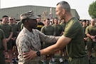 U.S. Marine Corps Brig. Gen. Stephen J. Lightfoot, commanding general of Naval Amphibious Force, Task Force 51/5th Marine Expeditionary Brigade (TF 51/5), congratulates Sgt. Tafari D. Galloway, an administrative clerk with TF 51/5, on returning from his meritorious promotion at the Pentagon for his efforts during the recent 12-day regional conflict, at Naval Support Activity, Bahrain on Nov. 13, 2025. TF 51/5 participated in a unit-wide physical training session to commemorate the 250th anniversary of the United States Marine Corps, fostering esprit de corps and camaraderie. (U.S. Navy photo by Mass Communication Specialist 2nd Class Kade Bise)