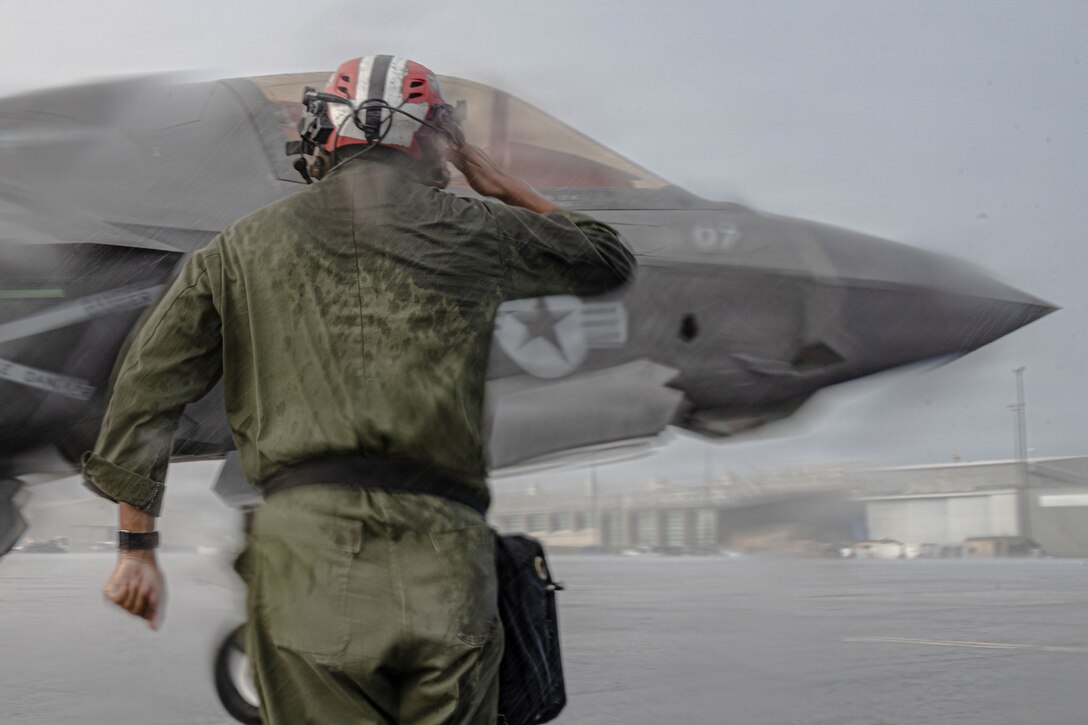 A U.S. Marine Corps ordnance technician with Marine Fighter Attack Squadron (VMFA) 225, U.S. Marine Corps Forces, South, salutes a U.S. Marine Corps F-35B Lightning II pilot with VMFA-225 at Jose Aponte de la Torre Airport in Ceiba, Puerto Rico, Nov. 26, 2025. U.S. military forces are deployed to the Caribbean in support of the U.S. Southern Command mission, Department of War-directed operations, and the president’s priorities to disrupt illicit drug trafficking and protect the homeland. (U.S. Marine Corps photo)