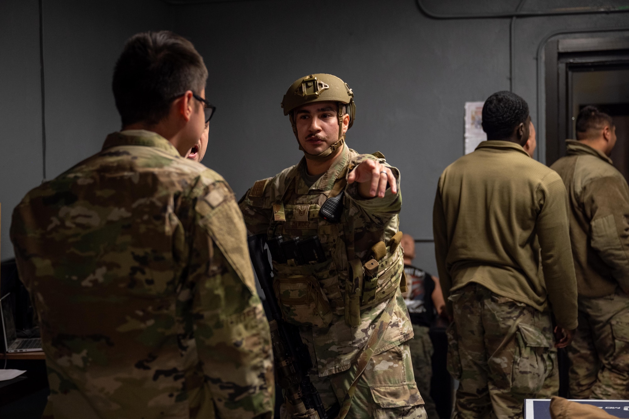 U.S. Air Force Staff Sgt. Joshua Ramirez, 7th Security Forces Squadron response force leader, directs participants to safety during an active shooter exercise at Dyess Air Force Base, Texas, Dec. 3, 2025. The exercise scenario reinforced the unit’s ability to rapidly move personnel out of danger while maintaining situational awareness. (U.S. Air Force photo by Airman 1st Class Adrien Tran)