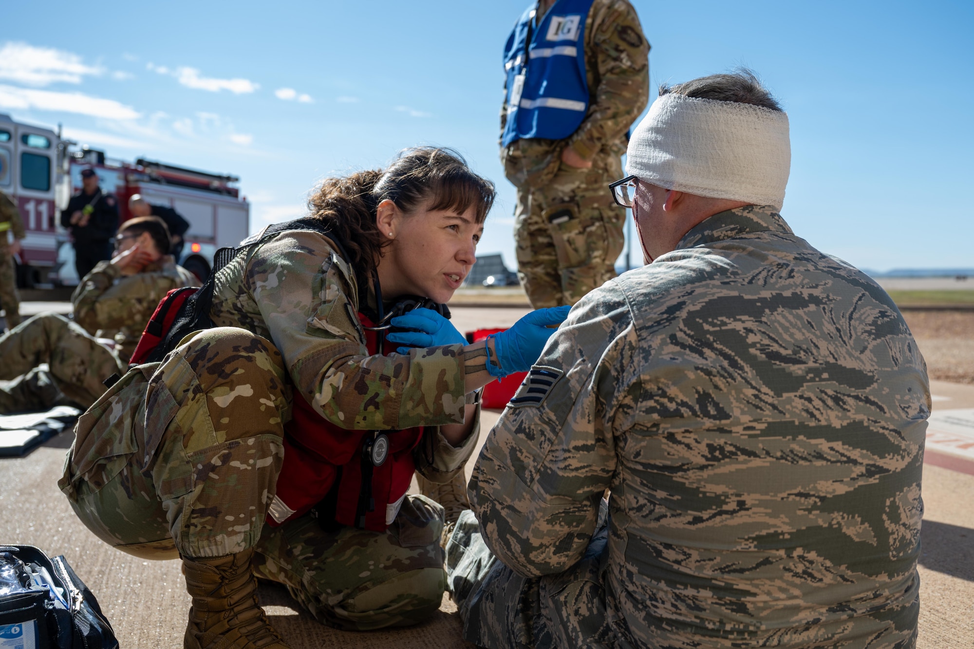 U.S. Air Force Staff Sergeant Tabitha Sunderson, 7th Operational Medical Readiness Squadron medical technician, provides care to a simulated victim during an active shooter exercise at Dyess Air Force Base, Texas, Dec. 3, 2025. Medical personnel evaluated and treated injuries to demonstrate the base’s emergency response capability. (U.S. Air Force photo by Airman 1st Class Adrien Tran)