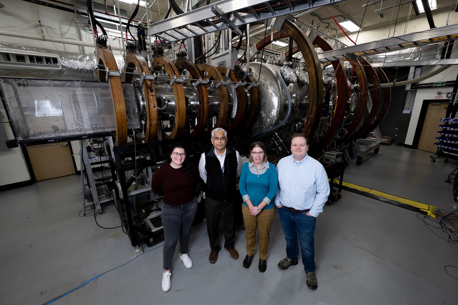 (Left)Emily Lichko, PhD, U.S. Naval Research Laboratory (NRL) Karles Fellowship, Gurudas Ganguli, PhD, NRL senior scientist, Ami M. DuBois, PhD, NRL research physicist), Chris Crabtree, PhD, NRL section head, stand in front of NRL’s Space Physics Simulation Chamber in Washington, D.C., Nov. 12, 2025. Lichko, Ganguli, DuBois and Crabtree worked together studying the electric field link that triggers magnetic reconnection in space that could help with predicting disruptive space weather events when they are about to occur. (U.S. Navy photo by Jonathan Steffen-Arnold)