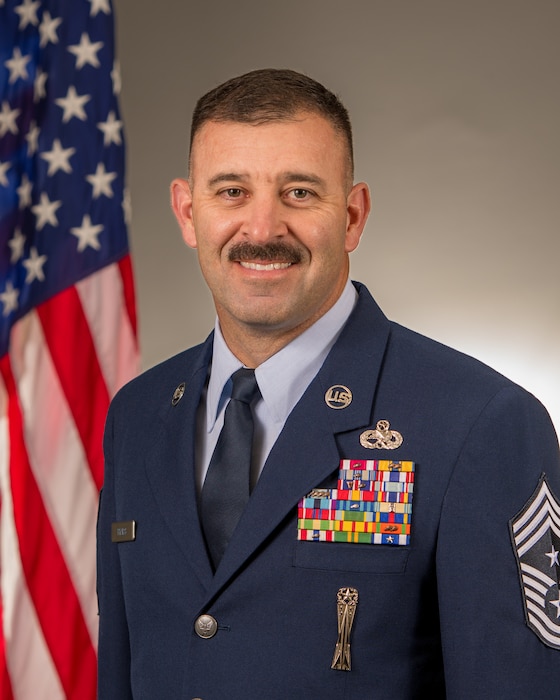 U.S. Air Force Chief Master Sgt. William E. Ryals III, wing command chief, 125th Fighter Wing, poses for an official photo in his Air Force blues uniform.