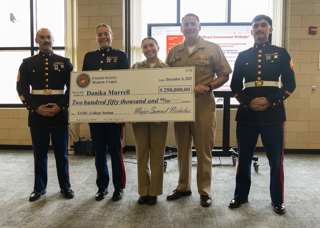 U.S. Marines with Recruiting Sub-Station Georgetown, Recruiting Station Austin, U.S. Navy Admiral Matthew T. Pottenburgh, Commanding Officer, Naval Service Training Command and Danika Murrell, a student with East View High School pose for a photo during a Naval Reserve Officer Training Corps scholarship presentation at East View High School in Georgetown, Texas, Dec. 4, 2025. Students selected for this prestigious scholarship program must uphold strict physical fitness standards and successfully complete additional military courses while maintaining normal college coursework responsibilities. (U.S. Marine Corps photo by Sgt. Jose D. Cruz)