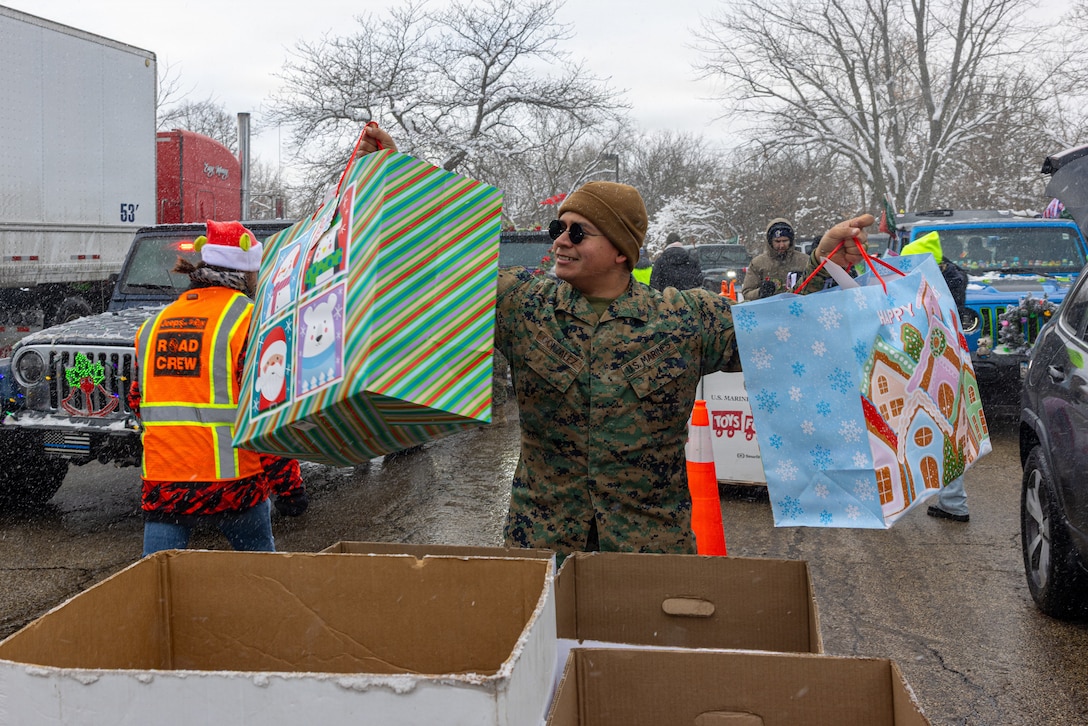 U.S. Marine Corps Cpl. Daniel Gonzalez, a logistics specialist with MACG-48, places toys in a collection bin during a Toys for Tots drive in Lincolnshire, Illinois, on Dec 7, 2025. Toys for Tots is a charitable program founded by the U.S. Marine Corps Reserve in 1947 to bring unwrapped toys to children in need. It has grown into a nationwide effort that distributes millions of toys each year, symbolizing generosity and holiday spirit. (U.S. Marine Corps photo by Lance Cpl. Kayla Goldman)