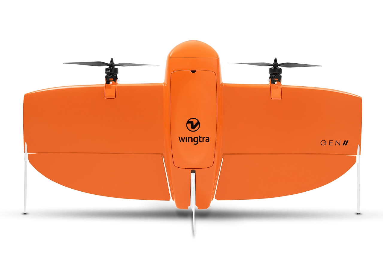 A wide-winged drone with two propellers sits upright.