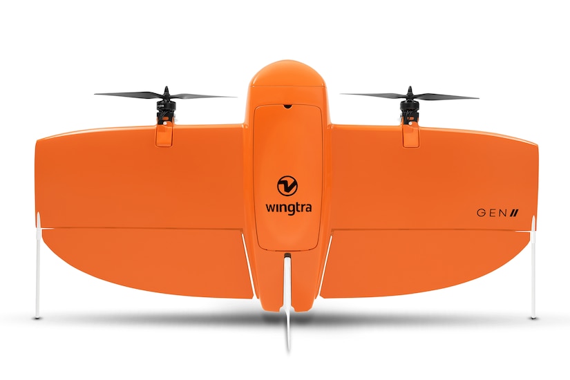 A wide-winged drone with two propellers sits upright.