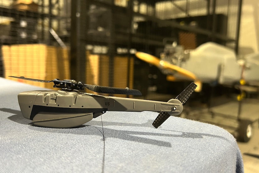 A small drone sits on a table.