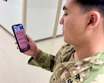 U.S. Army Soldier Staff Sgt. Francisco Martinez, assigned to Munson Army Health Center, Fort Leavenworth, Kansas uses a cell phone to access the MHS GENESIS Patient Portal, Dec. 9.  The MHS GENESIS Patient Portal is a secure website for 24/7 access to your healthcare information, including managing appointments, and exchanging messages with the healthcare team anytime and anywhere. The health center is testing online appointment booking through the MHS GENESIS Patient Portal to provide patients 24/7 appointing access.
