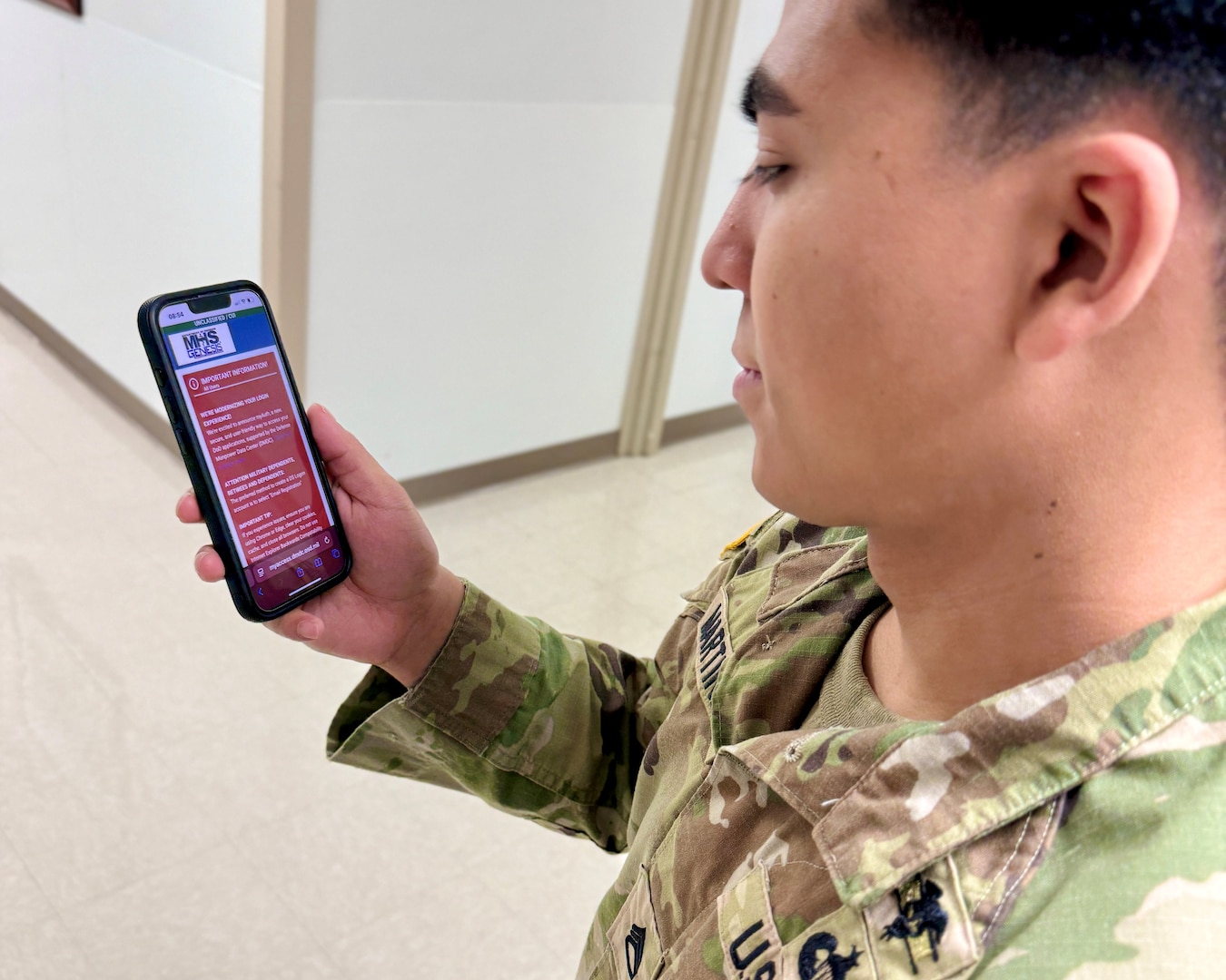 U.S. Army Soldier Staff Sgt. Francisco Martinez, assigned to Munson Army Health Center, Fort Leavenworth, Kansas uses a cell phone to access the MHS GENESIS Patient Portal, Dec. 9.  The MHS GENESIS Patient Portal is a secure website for 24/7 access to your healthcare information, including managing appointments, and exchanging messages with the healthcare team anytime and anywhere. The health center is testing online appointment booking through the MHS GENESIS Patient Portal to provide patients 24/7 appointing access.