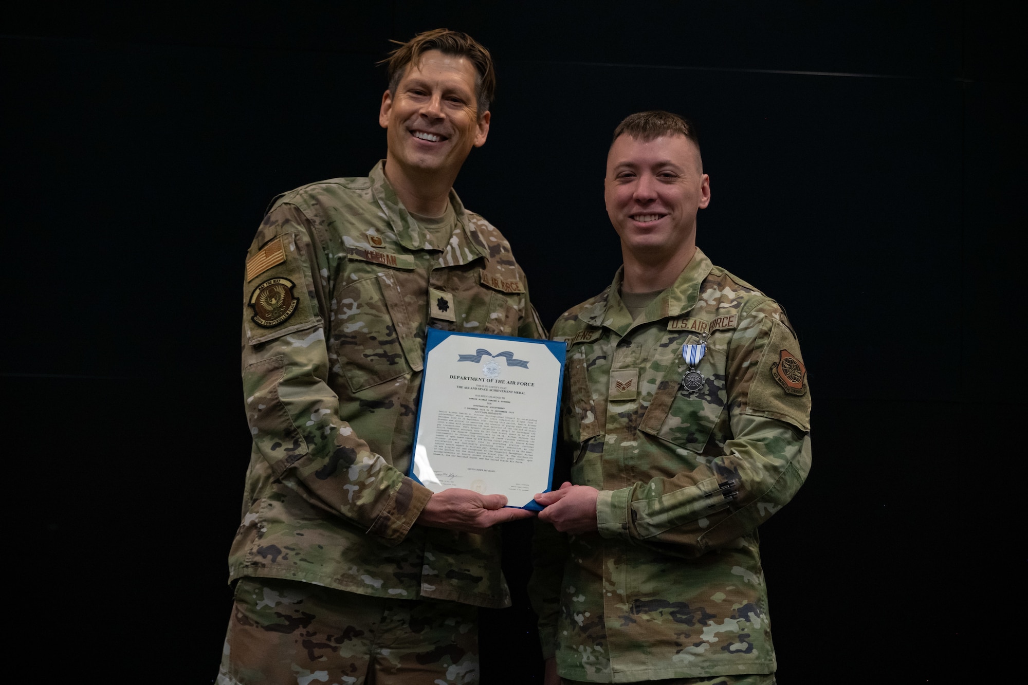 Lt. Col. Timothy Keegan awards SrA Damien Stevens with an Air and Space Achievement,