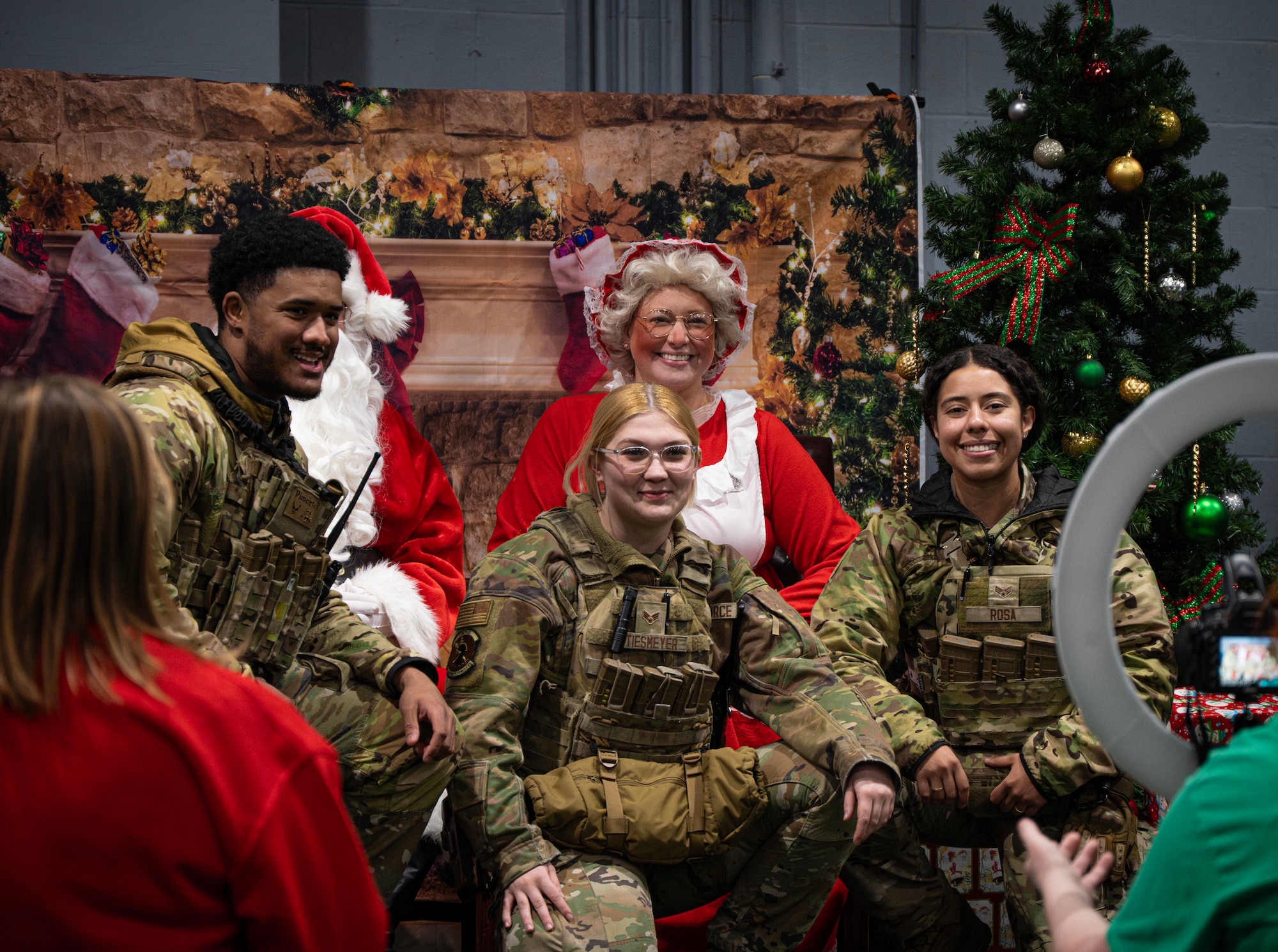 5th Security Forces Airmen pose with Mr. & Mrs. Claus during Team Minot’s Frostival at Minot Air Force Base, North Dakota, Dec. 6, 2025. Events such as these strengthen community bonds and provide Airmen with a sense of connection and holiday cheer. (U.S. Air Force photo by Senior Airman Alyssa Bankston)