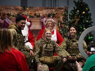 5th Security Forces Airmen pose with Mr. & Mrs. Claus during Team Minot’s Frostival at Minot Air Force Base, North Dakota, Dec. 6, 2025. Events such as these strengthen community bonds and provide Airmen with a sense of connection and holiday cheer. (U.S. Air Force photo by Senior Airman Alyssa Bankston)
