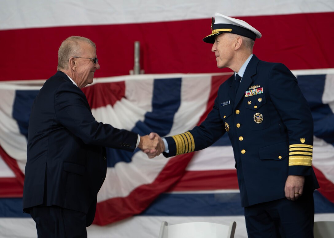 U.S. Coast Guard Adm. Kevin Lunday, acting commandant of the Coast Guard, shakes hands with Congressman Mike Ezell, U.S. Representative for Mississippi’s Fourth Congressional District, during a Keel laying ceremony in Mobile, Alabama, Dec. 8, 2025. Austal USA hosted the keel laying ceremony for the first Heritage-Class Offshore Patrol Cutters to be built in their Mobile Shipyard.