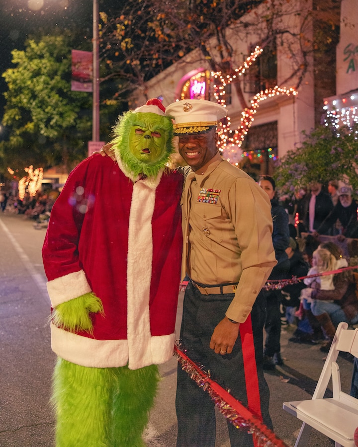 U.S. Marine Corps Brig. Gen. Brown, right, the commanding general of Marine Corps Installations West, Marine Corps Base Camp Pendleton, stands for a photo with a parade participant during the 44th Annual Fallbrook Christmas Parade in Fallbrook, California, on Dec. 6, 2025. Once a year, the city hosts a parade to celebrate Christmas and spread holiday cheer throughout the community. (U.S Marine Corps photo by Sgt. Rafael).