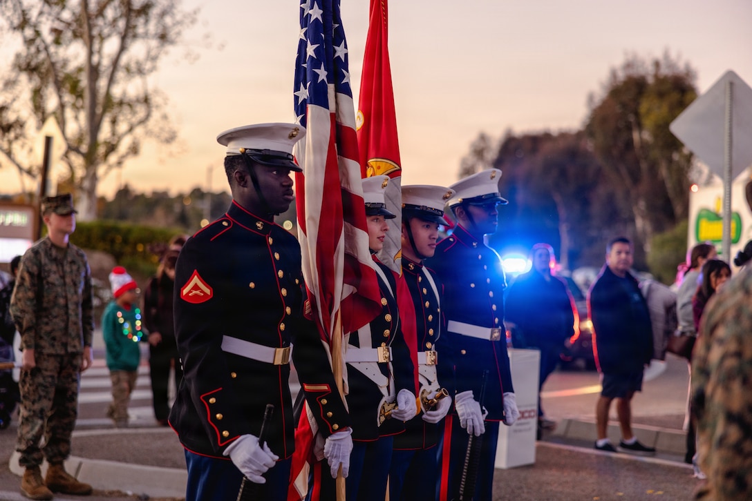 The Color Guard for Headquarters and Support Battalion, Marine Corps Installations West, carry the colors at the 44th Annual Fallbrook Christmas Parade in Fallbrook, California, on Dec. 6, 2025. Once a year, the city hosts a parade to celebrate Christmas and spread holiday cheer throughout the community. (U.S Marine Corps photo by Sgt. Rafael).